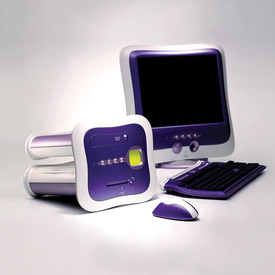A purple and white desktop computer set with a monitor, keyboard, mouse, and modular CPU.