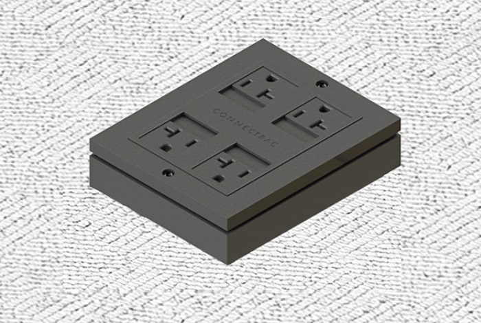 A black electrical outlet panel with four sockets mounted on a textured white wall.