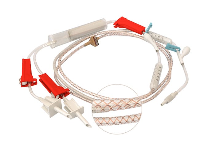 Close-up image of a medical infusion set with multiple ports, connectors, and a detailed view of the tubing texture.